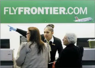  ?? THE ASSOCIATED PRESS ?? A Frontier Airlines employee directs passengers at Cleveland Hopkins Internatio­nal Airport in Cleveland.