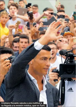  ??  ?? Cristiano Ronaldo saluda a una multitud a su llegada a la revisión médica, ayer en Turín.