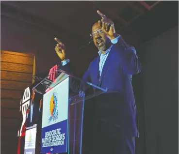  ?? AP PHOTO/JEFF AMY ?? Democratic U.S. Sen. Raphael Warnock exhorts the crowd Aug. 27 at the Democratic Party of Georgia convention in Columbus, Ga.