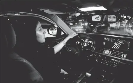  ?? NARIMAN EL-MOFTY/AP ?? Hessah al-Ajaji takes a midnight drive down Riyadh’s busy Tahlia Street after Saudi Arabia lifted its ban on female drivers Sunday. The ban was lifted as part of a package to loosen the rigid rules governing the country.
