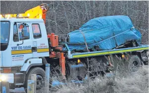  ??  ?? Wreckage of the car involved in the collision at the Snowman Rally is taken away