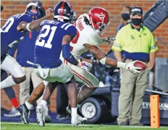  ?? ALABAMA PHOTO/ KENT GIDLEY ?? Alabama senior running back Najee Harris reaches the ball across the goal line for one of his five touchdowns last Saturday night at Ole Miss.