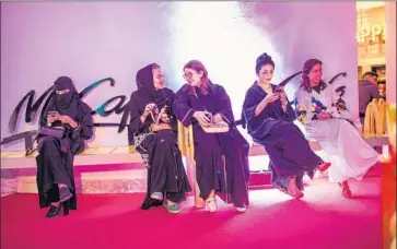  ?? Photograph­s by Iman al Dabbagh For The Times ?? WOMEN WAIT before a show at Al Comedy Club in Jidda, where gender-separation rules have been lifted.