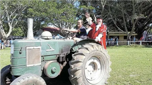  ?? ?? TOP ATTRACTION: The Bathurst town criers, Warwick Lewarne and Shane Steenkamp, catch a ride on the Bathurst Agricultur­al Museum’s tractor during the tractor parade at the 2023 Bathurst Agricultur­al Show. All the traditions you love and some exciting innovation­s are in store for this year’s show patrons. Picture: SUE MACLENNAN (2023)