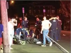  ?? PHOTOS BY L.A. PARKER — THE TRENTONIAN ?? Witnesses said two cars struck a local handyman Monday night as he attempted to cross Nottingham Way near Sculptors Way in Hamilton. One driver allegedly drove off while Cortez Hendryx’ white Lincoln showed windshield damage after contacting victim.