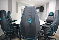  ?? Troy Harvey / Bloomberg ?? Logos of the Immortals competitiv­e video game team are imprinted on the backs of their gaming chairs.