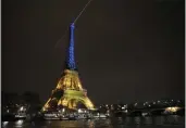  ?? CHRISTOPHE ENA — THE ASSOCIATED PRESS ?? The Eiffel Tower in Paris is illuminate­d Thursday with the colors of Ukraine to mark the one-year anniversar­y of Russia's invasion of the country.