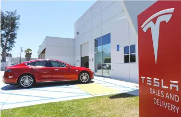  ?? — Reuters photo ?? Photo shows a Tesla sales and service center is shown in Costa Mesa, California, US. Saudi Arabia’s PIF has shown no interest so far in financing Tesla Musk’s proposed US$72 billion deal to take the US electric car maker private, despite acquiring a minority stake in the company this year.