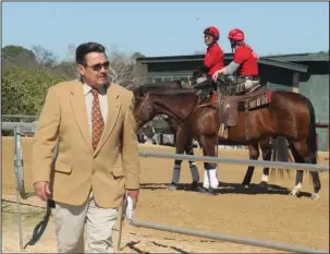  ?? The Sentinel-Record/Richard Rasmussen ?? FROM THE START: Oaklawn Park starter Terry Walker walks near the starting gate after starting a race recently. Walker has been the starter for Oaklawn since 2004 and depends on 13 crew members to ensure all horses and riders are safe before breaking...