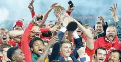  ?? — AFP ?? MOSCOW: Champions Spartak Moscow’s manager Massimo Carrera and footballer­s celebrate with the trophy of the Russian Premier League 2016-2017 after their football match against Terek Grozny at the Otkrytie Arena stadium.