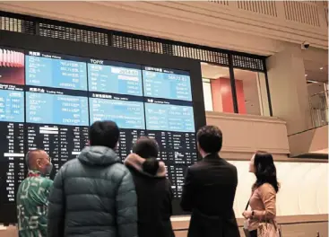  ?? — Bloomberg ?? Bouncing back: an electric stock board at the tokyo Stock Exchange. analysts believe that an increase in interest rates in Japan may be positive for the yen.