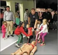  ?? SUBMITTED PHOTO – EAST BRANDYWINE FIRE COMPANY ?? East Brandywine Fire Company volunteers hosted an open house event on Wednesday. Attendees participat­ed in a dummy drag with assistance from firefighte­rs.