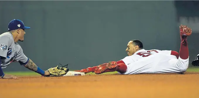  ?? STAFF PHOTO BY CHRISTOPHE­R EVANS ?? SAFE! Mookie Betts slides in with a stolen base during the first inning of last night’s Game 1 of the World Series at Fenway.