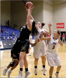  ?? Photo courtesy of JBU Sports Informatio­n ?? John Brown University women’s basketball players Baily Cameron and Jana Schammel battle Ecclesia players for the ball during a game earlier this season. The Golden Eagles return to action at home at 6 p.m. Thursday against Southweste­rn Christian (Okla.).