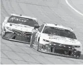  ??  ?? Kyle Larson, right, and Denny Hamlin race during the NASCAR Cup Series FireKeeper­s Casino 400 on Aug. 22 at Michigan Internatio­nal Speedway.
LOGAN RIELY/GETTY