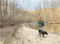  ?? HOLLAND ?? Jeff Holland and Millie stroll along the McKeldin Rapids Trail in Marriottsv­ille.JEFF