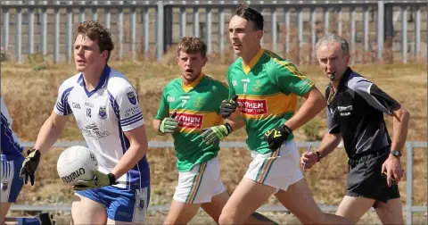  ??  ?? Páraic Redmond of Craanford coming out of defence as Clongeen duo Richard Rochford and Shane Cahill give chase.