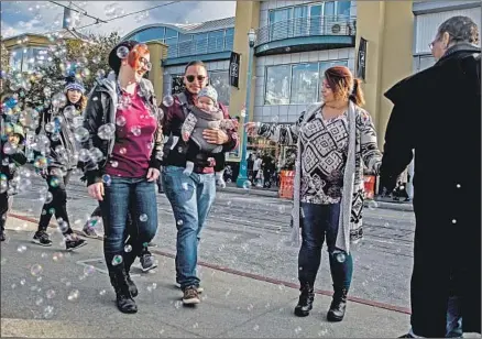  ?? Photograph­s by Stephen Lam For The Times ?? TINA BEJARANO GARDERE, center, with her son Kristin Cooke, his wife, and their daughter, Scarlet. Bejarano Gardere and Cooke were reunited for the first-time this week, 29 years after she gave birth to a baby and immediatel­y gave it up for adoption.