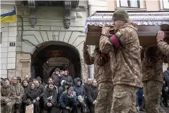  ?? Photo/Petros Giannakour­is) ?? People pay their respects as soldier carry the coffin of soldier Roman Tsyhanskyi during a funeral ceremony Friday outside the Holy Apostles Peter and Paul Church in Lviv, western Ukraine. Tsyhanskyi died near Bakhmut a week ago.(AP