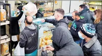  ?? ?? People queue for bread inside a bakery in the southern Beirut suburb of Dahiyeh, Lebanon, March 15, 2022. Lebanese Minister of Economy and Trade Amin Salam said Tuesday, April 19, 2022, that Lebanon is close to reaching an agreement with the World Bank in which the internatio­nal agency would give the crisis-hit country a $150 million loan for food security and to stabilize bread prices for the next six months. (AP)