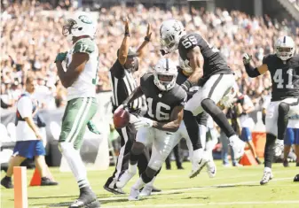  ?? Scott Strazzante / The Chronicle ?? The Raiders’ Johnny Holton (16) reacts to recovering Charone Park’s muff of a second-quarter punt. The recovery set up Marshawn Lynch’s touchdown run, which gave Oakland a 21-10 lead.