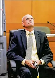  ??  ?? Criminal scene analyst Ross Martin Gardner reacts as he tries to demonstrat­e the various ways that the gun used during the McIver accident could have been held in the car while testifying Friday.