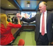  ?? GEORGE WALKER IV/THE TENNESSEAN VIA AP ?? Tennessee state Sen. Steve Dickerson gets a high five from Rebecca Lofty at his campaign headquarte­rs Tuesday in Nashville after his win in the 2016 election.