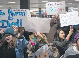  ?? PAUL J. RICHARDS / AFP / GETTY IMAGES ?? Protesters gather at the Washington Dulles Internatio­nal Airport, where two Yemeni brothers arrived last Saturday and were quickly put on a return flight to Ethiopia.