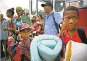  ?? RAMON ESPINOSA/ASSOCIATED PRESS ?? Families seeking shelter ahead of Hurricane Matthew arrive at a school Monday in Guantanamo, Cuba.