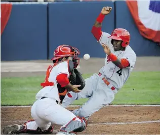  ?? MARK VAN MANEN/ PNG ?? Saquan Johnson of the Spokane Indians makes it home safely Monday night as catcher Daniel Klein of the Vancouver Canadians can’t come up with the ball at Nat Bailey Stadium. The C’s lost 10- 1 and are 1- 3 after four games in the Northwest League...