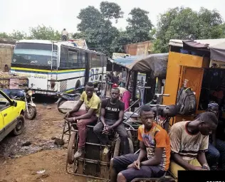  ??  ?? CONTRASTI Ragazzi in attesa alla Gare de Bamako, nella capitale del Mali, snodo principale per i pullman dei migranti; Boubou Diaby, 16 anni, cuoco in un ristorante italiano a Parigi, sugli Champs-Élysées.