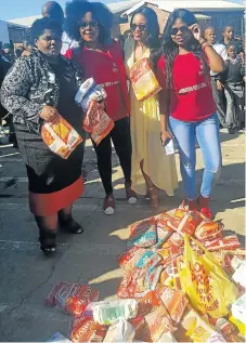  ?? Picture: SUPPLIED ?? HEARTY FOOD: Mrs Africa finalist Yonela Jindela, in yellow, and her friends Babalwa Mbuku, second from left, and Khanya Njengele, right, of Operation Feed a Child donated porridge to Sinomonde Primary pupils in Orange Grove. Teacher Thembeka Sompa,...