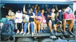  ?? (Ali Vicoy) ?? TALISAY residents board a military truck to evacuate to safer grounds after Taal Volcano’s phreatic eruption on Sunday, January 12, 2020.