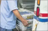  ?? J. SCOTT APPLEWHITE — THE ASSOCIATED PRESS ?? Letter carriers load mail trucks for deliveries at a U.S. Postal Service facility in McLean, Va. The success of the 2020 presidenti­al election could come down to the U.S. Postal Service.