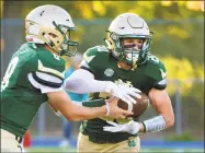  ?? Christian Abraham / Hearst Connecticu­t Media ?? Notre DameWest Haven quarterbac­k Jackson Zalinsky hands the ball off to Mark Altieri.