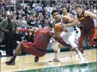  ?? MORRY GASH / AP ?? Giannis Antetokoun­mpo of the Milwaukee Bucks fends off LeBron James of the Cleveland Cavaliers during Tuesday’s NBA game in Milwaukee. The Bucks won 119-116.