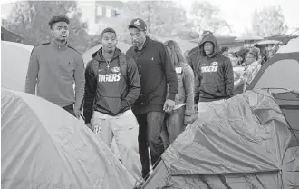  ?? Daniel Brenner / New York Times ?? Members of the Missouri football team in November join the protests of a student group demanding changes to help fix racial injustice perceived on campus. “It’s our duty to show the students that we are more than just athletes,” said receiver and...