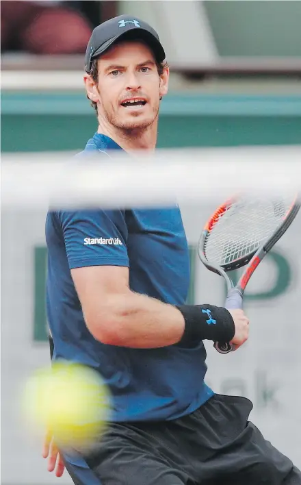  ?? — THE ASSOCIATED PRESS ?? Britain’s Andy Murray returns the ball to Argentina’s Juan Martin del Potro during their third round match at the French Open on Saturday in Paris. Murray won 7-6, 7-5, 6-0.