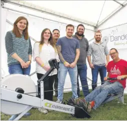  ?? Picture: Andy Jones FM4524676 ?? Richard Pike on the rowing machine watched by staff from food company Cook