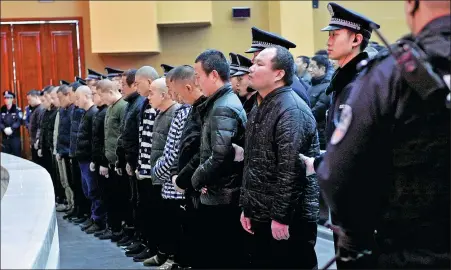  ?? QIANG JUN / FOR CHINA DAILY ?? A mafia-style crime gang is sentenced at Lintong District People’s Court in Xi’an, Shaanxi province, in January.