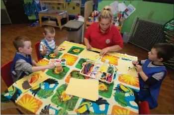  ??  ?? Kids at the Monkey Puzzle Nursery in the Gorbals