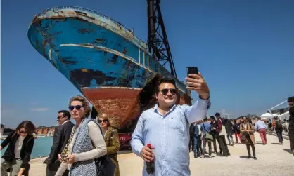  ??  ?? A man takes a selfie in front of Barca Nostra, at the Venice Biennale. ‘Can something so raw and so touched with recent and undigested human catastroph­e really have a role in an art exhibition?’ Photograph: David Levene/The Guardian