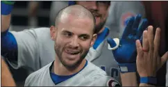  ?? AP PHOTO/ JOHN AMIS ?? Chicago Cubs' Tommy La Stella celebrates after hitting a two-run home run against the Atlanta Braves, Thursday.