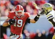  ?? John Bazemore / Associated Press ?? Georgia tight end Brock Bowers runs the ball during the first half against Georgia Tech last Saturday in Athens, Ga.