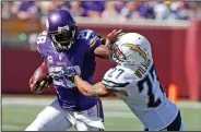  ?? AP PHOTO ?? Minnesota Vikings running back Adrian Peterson pushes off the tackle of San Diego Chargers strong safety Jimmy Wilson on his way to a touchdown.