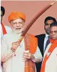  ?? PHOTO: PTI ?? Prime Minister Narendra Modi being presented a sword at a rally in Dhandhuka village of Ahmedabad district on Wednesday.