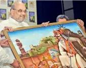  ?? — PTI ?? Union home minister Amit Shah receives a memento during the launch of a book in New Delhi, on Friday.