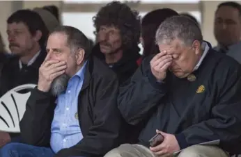  ?? ANDREW VAUGHAN/THE CANADIAN PRESS ?? Friends and family attend a memorial service Tuesday to honour the 26 coal miners killed on May 9, 1992.