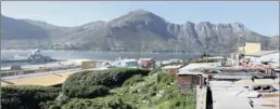  ??  ?? UP FOR DEVELOPMEN­T: Residents fear they may be forced to move after the city announced it’s intention to develop the land it bought directly below their homes in Hangberg, Hout Bay.