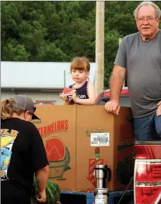  ??  ?? Four-year-old Sarah Clay, of Pineville, finds the perfect throne to enjoy her watermelon during Southwest City’s Third of July Celebratio­n. Clay waited patiently while her family helped to distribute a portion of the five tons of free watermelon that was available.